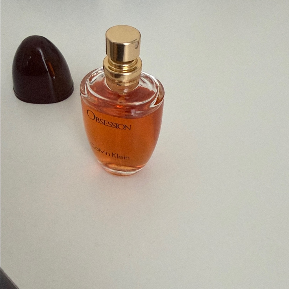 Calvin Klein Obsession Fragrance with Rich Brown and Orange Hues - Picture 4 of 4